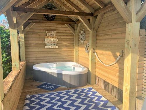 a sauna with a hot tub in a wooden building at 1 Bed in Lymington oc-50723 in Sway