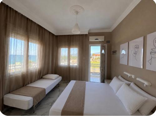 a bedroom with two beds and a window at Basilio's Studios in Leptokarya