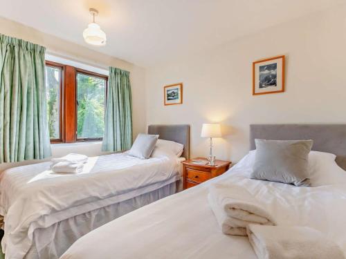 a bedroom with two beds and a window at 2 Bed in Skipton oc-92898 in Airton