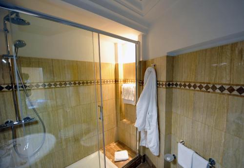 a bathroom with a glass shower and a sink at Angel Spagna Suite in Rome