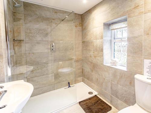 a bathroom with a tub and a toilet and a sink at 1 Bed in Sheffield oc-48259 in Thurlstone