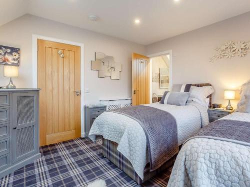 a bedroom with two beds and a window at 2 Bed in Lairg oc-86104 in Durness