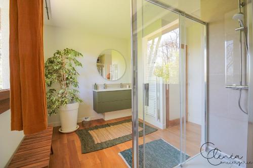 a bathroom with a shower and a sink and a mirror at Green Oak Windows & Wood in Albi