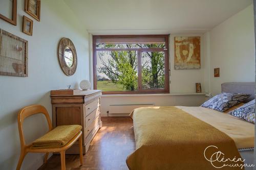 a bedroom with a bed and a dresser and a window at Green Oak Windows & Wood in Albi