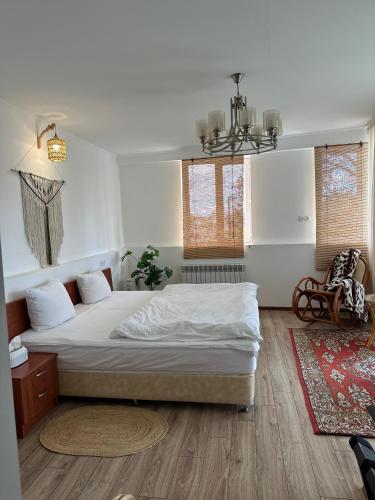 a bedroom with a large bed and a rug at TAGANI Guest Rooms in Martuni