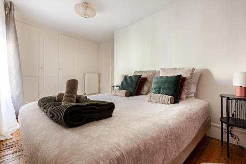 a bedroom with a bed with a blanket on it at Le 120 Amiens in Amiens
