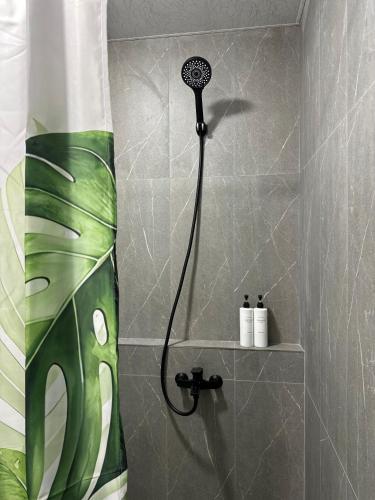 a shower with a black shower head in a bathroom at TAGANI Guest Rooms in Martuni