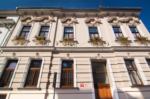 a building with windows and flower boxes on it at Apartmány - Penzion Smetanka in České Budějovice