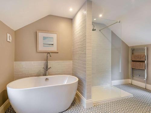 a large white tub in a bathroom with a shower at 2 Bed in Hope Valley oc-88979 in Sheffield