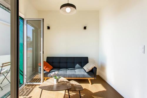 a living room with a couch and a table at Coastline Studio Apartment Ligia Bay in Lygia
