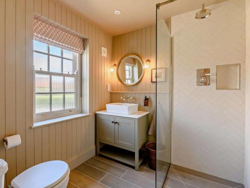 a bathroom with a toilet and a sink and a mirror at 2 Bed in Helmsley oc-92946 in Helmsley