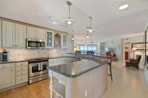 a large kitchen with white cabinets and a counter top at Islamorada Oceanfront Luxury Living in Islamorada
