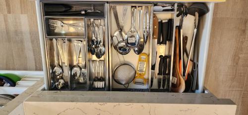 a drawer filled with lots of kitchen utensils at Anona Beachfront Villa in Filadu