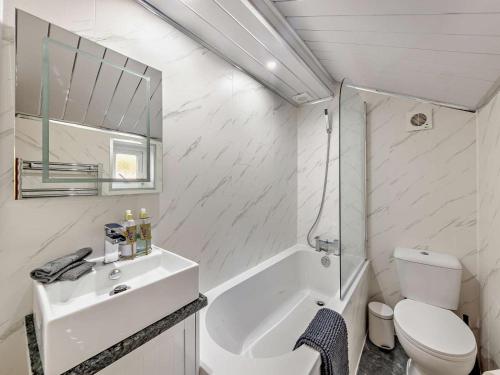 a white bathroom with a sink and a toilet at 2 Bed in Kelsall oc-94445 in Kelsall