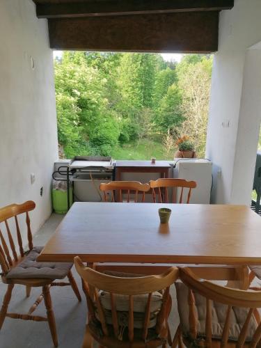 a table and chairs in a room with a window at Apartmaji Karbic in Postojna