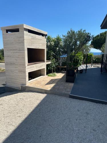 a wooden building with a ramp in a yard at Villa Helena in Trogir