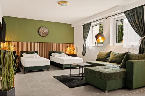 a living room with a couch and two beds at Modo Apartment in Erkelenz mit Sauna Pool in Erkelenz