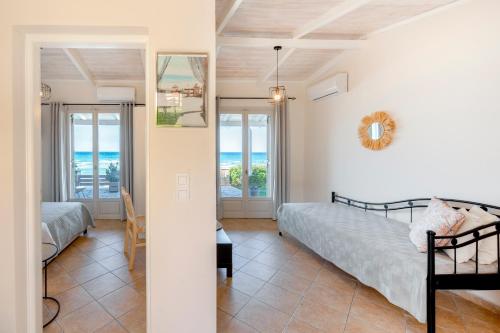 a bedroom with two beds and a view of the ocean at Garden Studios in Alykes