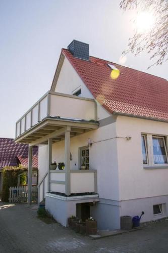 a white house with a red roof at Rügen Fewo 307 in Sagard