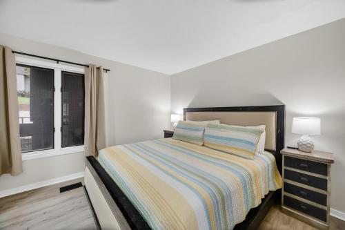 a small bedroom with a bed and a window at Indoor/Outdoor Pools!! Hot Tub! Steam Room! Sauna! in Osage Beach
