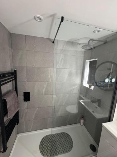 a bathroom with a shower and a sink at Serene escape in Cleator Moor