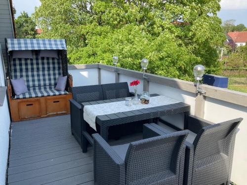a patio with a table and chairs on a deck at Rügen Fewo 307 in Sagard