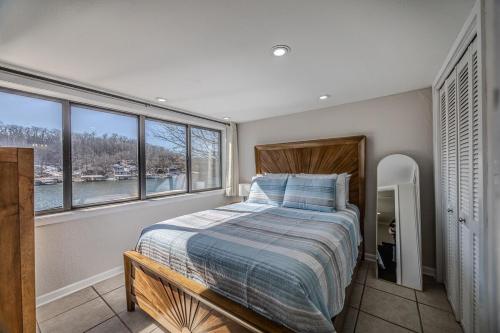 a bedroom with a bed and a large window at 22 Mile Marker! Indoor/Outdoor Pools, Hot Tub! New in Osage Beach
