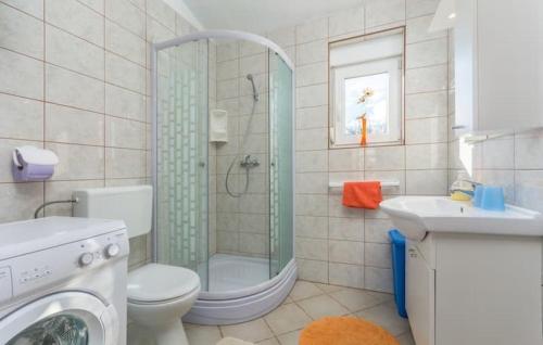 a bathroom with a shower and a toilet and a sink at Holiday house Casa Vida in Rakalj