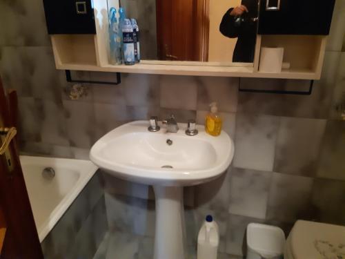 a bathroom with a sink and a toilet and a mirror at la casa nell'acropoli , piano terra in Arpino