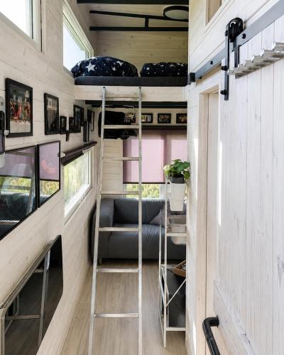an interior view of a tiny house with bunk beds at Boží maringotka in Humpolec
