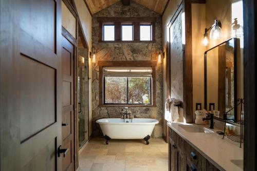 a bathroom with a large tub and a window at Zion Mountain Ranch in Mount Carmel Junction