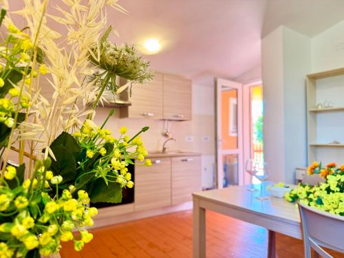 a kitchen with a table and a bunch of plants at La Nuova Rinascita in San Giovanni Suergiu