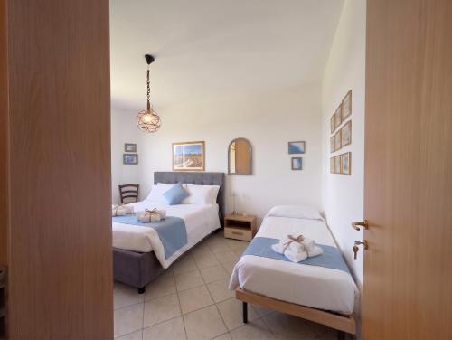 a hotel room with two beds and a doorway at -1 min dal mare- AC balcone e garage in Pedaso
