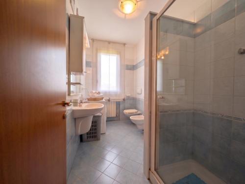 a bathroom with a sink and a toilet and a shower at -1 min dal mare- AC balcone e garage in Pedaso