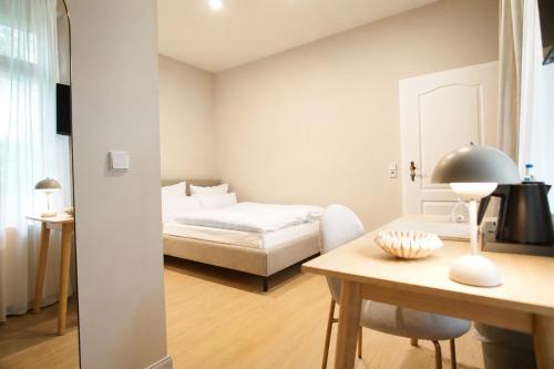 a bedroom with a bed and a desk and a table at Hotel Schloss Teutschenthal in Teutschenthal
