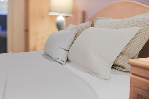 a white bed with two pillows on it at Portstewart promenade apartment with sea views in Portstewart