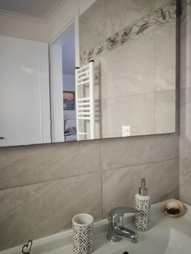 a bathroom with a sink and a mirror at Nostalgia Apartments B Plus in Sami 50 meters from the sea in Sami