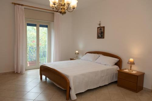 a bedroom with a large bed and a window at Natura e Relax Casa Emma in Buonvicino