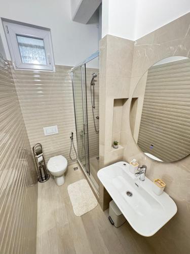 a bathroom with a sink and a shower and a toilet at Guest House Nova in Mostar