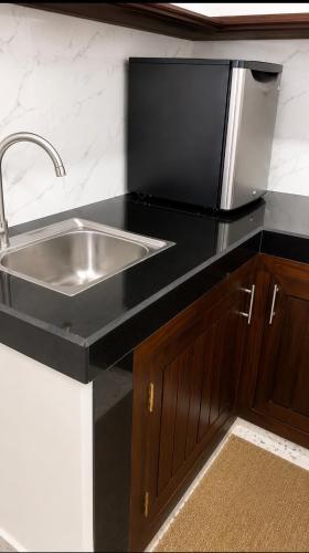 a kitchen with a stainless steel sink and a counter at AZORA Boutique Studios in Ahangama