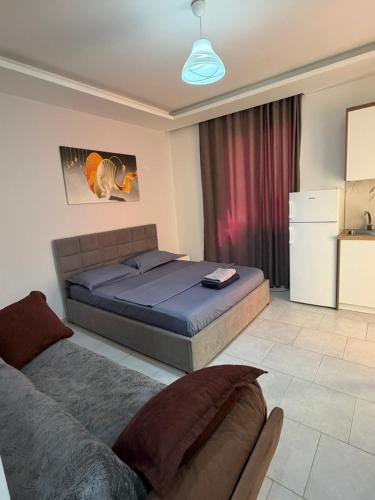 a bedroom with a bed and a couch in it at Sea flavor 2 in Shëngjin