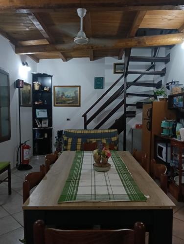 a dining room with a table and a staircase at Lo chalet del vicolo in Roccasecca dei Volsci