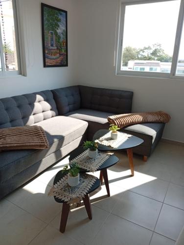 a living room with a couch and two tables at Habibi Cocoyoc in Cocoyoc