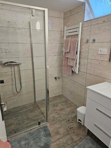 a bathroom with a shower and a toilet at Ágnes Apartmanok in Harkány
