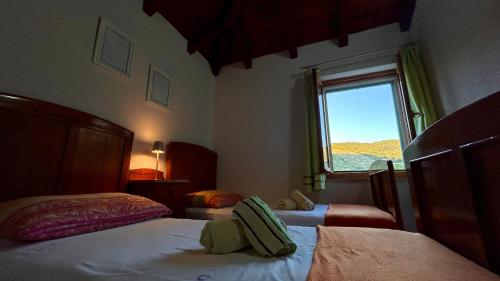 a hotel room with two beds and a window at Villa Olive in Dol