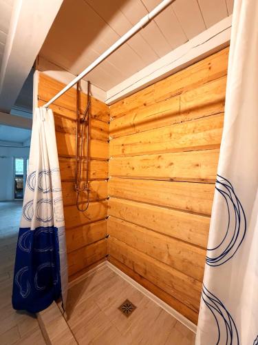 a corner of a room with a wooden wall at Brižių sodyba in Brižiai