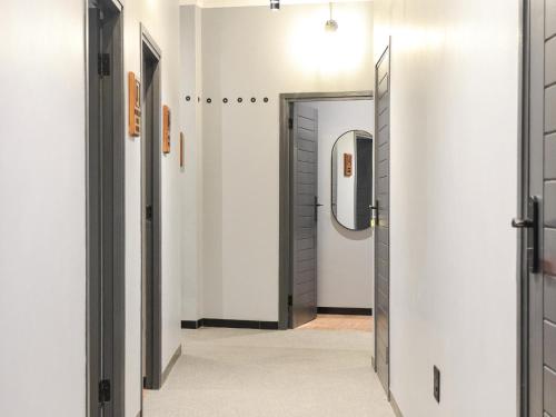 a hallway with a door and a mirror at The Siding Apartments in Hilton
