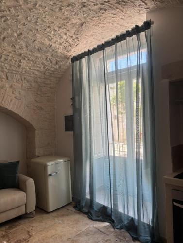 a living room with a window and a couch at Dimora Mavi' in Noci