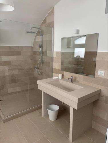 a bathroom with a sink and a shower at Dimora Mavi' in Noci
