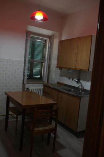 a kitchen with a wooden table and a table and chairs at la casa nell'acropoli , primo piano in Arpino